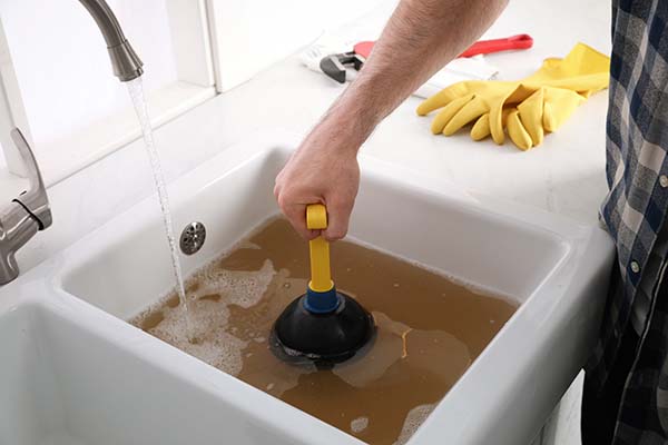 Plunger being used on blocked drain blackpool sink