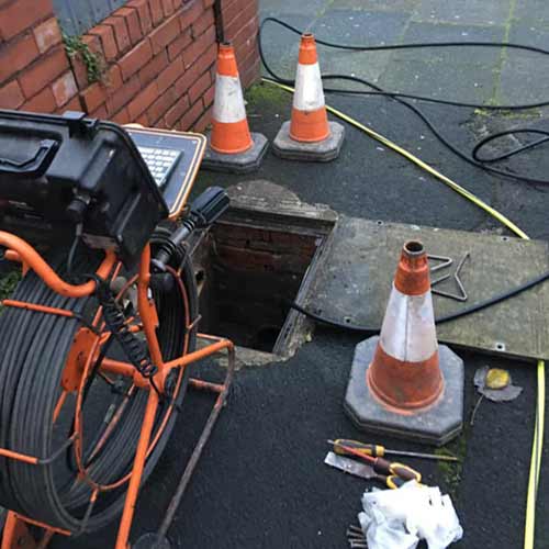 Emergency Drainage Service Staining - drainage job with safety cones